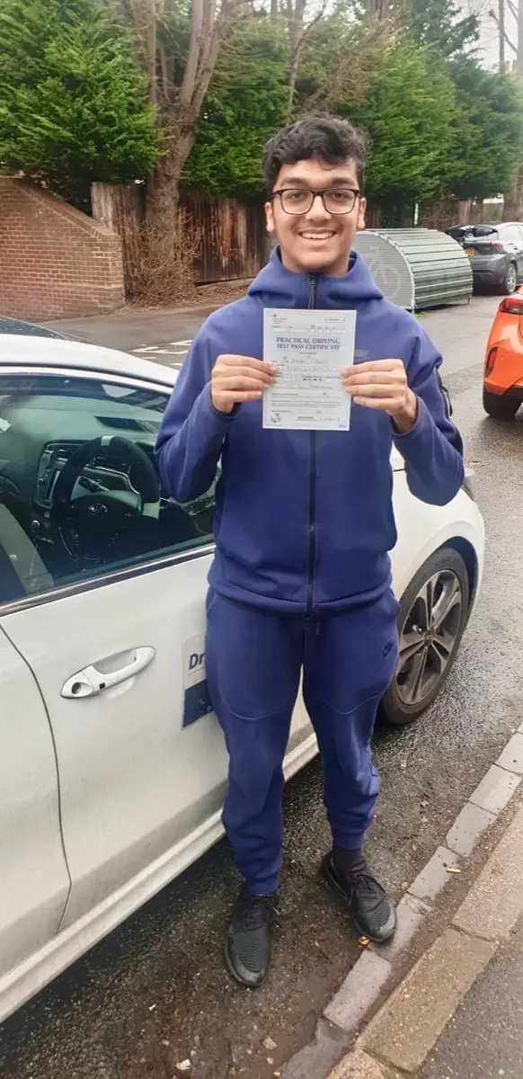 Young client holding his practical test pass certificate