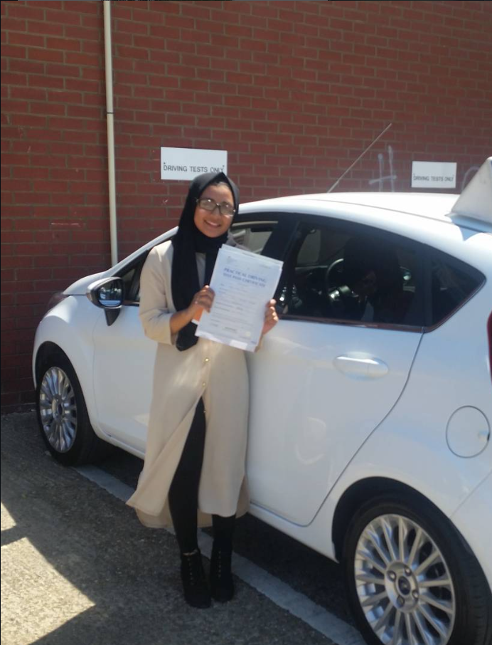 Client with her pass certificate outside the exam centre